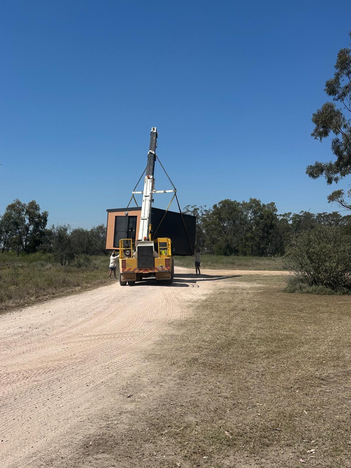 Portable accommodation transported by crane along a regional access road