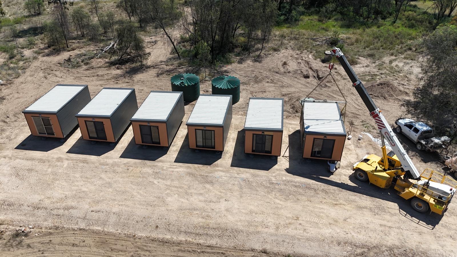 Six portable worker rooms and crane viewed from above